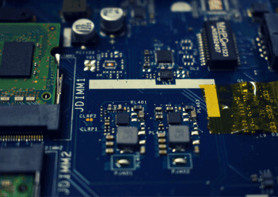 Close-up of a printed circuit board with electronic components, illustrating a PCB and embedded software design project